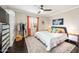 Comfortable bedroom with decorative pillows, a ceiling fan, dark hardwood floors, and a patterned rug at 3126 N 17Th Dr, Phoenix, AZ 85015