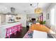 Bright dining room featuring an open-concept design, stylish chandelier, and modern kitchen with stainless hood at 3126 N 17Th Dr, Phoenix, AZ 85015