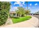 Beautifully landscaped front yard with lush lawn, mature trees, and a quaint walkway at 3126 N 17Th Dr, Phoenix, AZ 85015