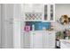 Wet bar area with wine storage, glass front cabinets, and quartz countertops at 3126 N 17Th Dr, Phoenix, AZ 85015