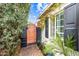 Charming side yard featuring a wooden gate, brick pathway, and lush landscaping at 3126 N 17Th Dr, Phoenix, AZ 85015