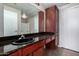 Well-lit bathroom featuring dark wood cabinets and granite countertops at 3302 N 7Th St # 108, Phoenix, AZ 85014