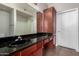 Bathroom features a granite countertop, a black sink, and dark wood cabinets at 3302 N 7Th St # 108, Phoenix, AZ 85014