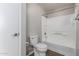 Clean bathroom with a shower-tub combo, toilet, and door to another part of the house at 3302 N 7Th St # 108, Phoenix, AZ 85014