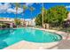 Sparkling community pool with lounge chairs, palm trees, and landscaped areas at 3302 N 7Th St # 108, Phoenix, AZ 85014