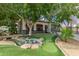 Beautiful apartment complex exterior featuring a serene pond and charming putting green at 3302 N 7Th St # 108, Phoenix, AZ 85014
