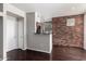 Cozy living space features hardwood floors and a brick accent wall, combining comfort and style at 3302 N 7Th St # 108, Phoenix, AZ 85014