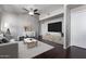 Bright living room with dark wood floors, modern furniture, and a large flat screen television at 3302 N 7Th St # 108, Phoenix, AZ 85014