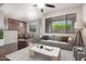 Cozy living room featuring exposed brick, comfortable seating, and lots of natural light from the windows at 3302 N 7Th St # 108, Phoenix, AZ 85014