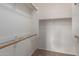 Walk-in closet featuring carpeted flooring, wooden racks, and white walls at 3302 N 7Th St # 108, Phoenix, AZ 85014
