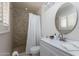 Bathroom featuring a modern vanity and a shower with stone pebble details at 3514 N 83Rd St, Scottsdale, AZ 85251