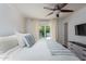 Light bedroom with ceiling fan, neutral walls, french doors, and stylish decor with a glimpse of the outdoors at 3514 N 83Rd St, Scottsdale, AZ 85251