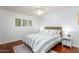 Cozy bedroom featuring a queen bed, ceiling fan, and a window with plantation shutters at 3514 N 83Rd St, Scottsdale, AZ 85251