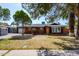 Charming brick home with well-maintained landscaping, a garage, and mature trees under a clear, sunny sky at 3514 N 83Rd St, Scottsdale, AZ 85251