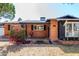 Charming brick home with a covered porch, dark shutters, manicured landscaping, and mature bougainvillea at 3514 N 83Rd St, Scottsdale, AZ 85251