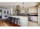 Kitchen with breakfast bar, custom cabinets, and stainless steel appliances at 3514 N 83Rd St, Scottsdale, AZ 85251