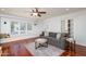 Cozy living room with hardwood floors, a large window seat, and a comfortable sofa at 3514 N 83Rd St, Scottsdale, AZ 85251