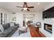 Open concept living room with fireplace, hardwood floors, and dining area at 3514 N 83Rd St, Scottsdale, AZ 85251