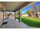 Covered patio overlooking a lush backyard with green grass, offering outdoor enjoyment and relaxation at 4330 W Aracely Dr, New River, AZ 85087
