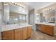 Bathroom featuring dual sinks, large mirrors, and tile flooring, adjacent to the bath and shower at 4330 W Aracely Dr, New River, AZ 85087