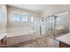 Bright bathroom featuring a separate shower and bathtub with tile flooring and natural light at 4330 W Aracely Dr, New River, AZ 85087