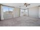 Bright bedroom featuring carpet, ceiling fan, and window coverings at 4330 W Aracely Dr, New River, AZ 85087
