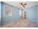 Bright blue bedroom featuring carpet, closet and ceiling fan at 4330 W Aracely Dr, New River, AZ 85087