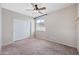 Neutral bedroom features plush carpet, ceiling fan, and double-door closet for ample storage at 4330 W Aracely Dr, New River, AZ 85087