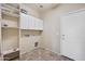 Functional laundry room with tile flooring, white cabinets and shelving for organized storage solutions at 4330 W Aracely Dr, New River, AZ 85087