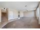 Open living area with stairs, neutral carpet, and access to other rooms at 4330 W Aracely Dr, New River, AZ 85087