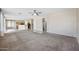 Open-concept living room with carpet, connecting to the kitchen with light wood cabinets at 4330 W Aracely Dr, New River, AZ 85087