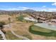 Scenic aerial view of community, highlighting the lush golf course, lake, and mountain views at 4515 E Rakestraw Ln, Gilbert, AZ 85298