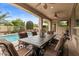 Backyard patio features ceiling fans, outdoor dining, and sparkling pool at 4515 E Rakestraw Ln, Gilbert, AZ 85298