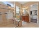 Bathroom with tiled shower, vanity and walk-in closet at 4515 E Rakestraw Ln, Gilbert, AZ 85298