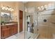 Lovely bathroom showcasing a glass shower, sleek vanity with marble countertops, and neutral tiling at 4515 E Rakestraw Ln, Gilbert, AZ 85298