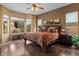 Comfortable bedroom with wood floors and backyard view at 4515 E Rakestraw Ln, Gilbert, AZ 85298