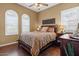 Comfortable bedroom features a ceiling fan, hardwood floors, and stylish decor at 4515 E Rakestraw Ln, Gilbert, AZ 85298