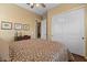Neutral bedroom featuring a ceiling fan, closet, and sliding door to another room at 4515 E Rakestraw Ln, Gilbert, AZ 85298