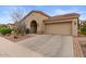 Beautiful home exterior with a desert landscape, attached garage and wide driveway at 4515 E Rakestraw Ln, Gilbert, AZ 85298