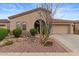 Charming home exterior features a well-manicured desert landscape and attached two-car garage at 4515 E Rakestraw Ln, Gilbert, AZ 85298