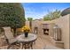 Outdoor seating around a cozy fireplace, complemented by desert landscaping and ambient lighting at 4515 E Rakestraw Ln, Gilbert, AZ 85298