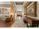 Hallway featuring stylish décor and tile floors leading to seating area with hardwood floors at 4515 E Rakestraw Ln, Gilbert, AZ 85298