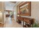 Hallway with stylish decor, artwork, and tile floors leads to an open living space at 4515 E Rakestraw Ln, Gilbert, AZ 85298