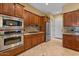 Gourmet kitchen with stainless steel appliances, granite countertops, and custom cabinetry at 4515 E Rakestraw Ln, Gilbert, AZ 85298