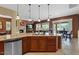 Modern kitchen featuring a central island with a sink and stainless steel appliances at 4515 E Rakestraw Ln, Gilbert, AZ 85298