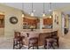 Spacious kitchen with island, granite counters, pendant lighting, and rich wood cabinetry at 4515 E Rakestraw Ln, Gilbert, AZ 85298