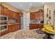 Bright kitchen with granite countertops, stainless steel appliances, and custom cabinetry at 4515 E Rakestraw Ln, Gilbert, AZ 85298