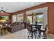 View of living area with wet bar and breakfast table overlooking pool at 4515 E Rakestraw Ln, Gilbert, AZ 85298