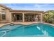 Sparkling pool with a view of the home's outdoor living space, perfect for entertaining guests at 4515 E Rakestraw Ln, Gilbert, AZ 85298