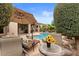 Inviting pool surrounded by lush landscaping and outdoor seating area with a sun umbrella at 4515 E Rakestraw Ln, Gilbert, AZ 85298